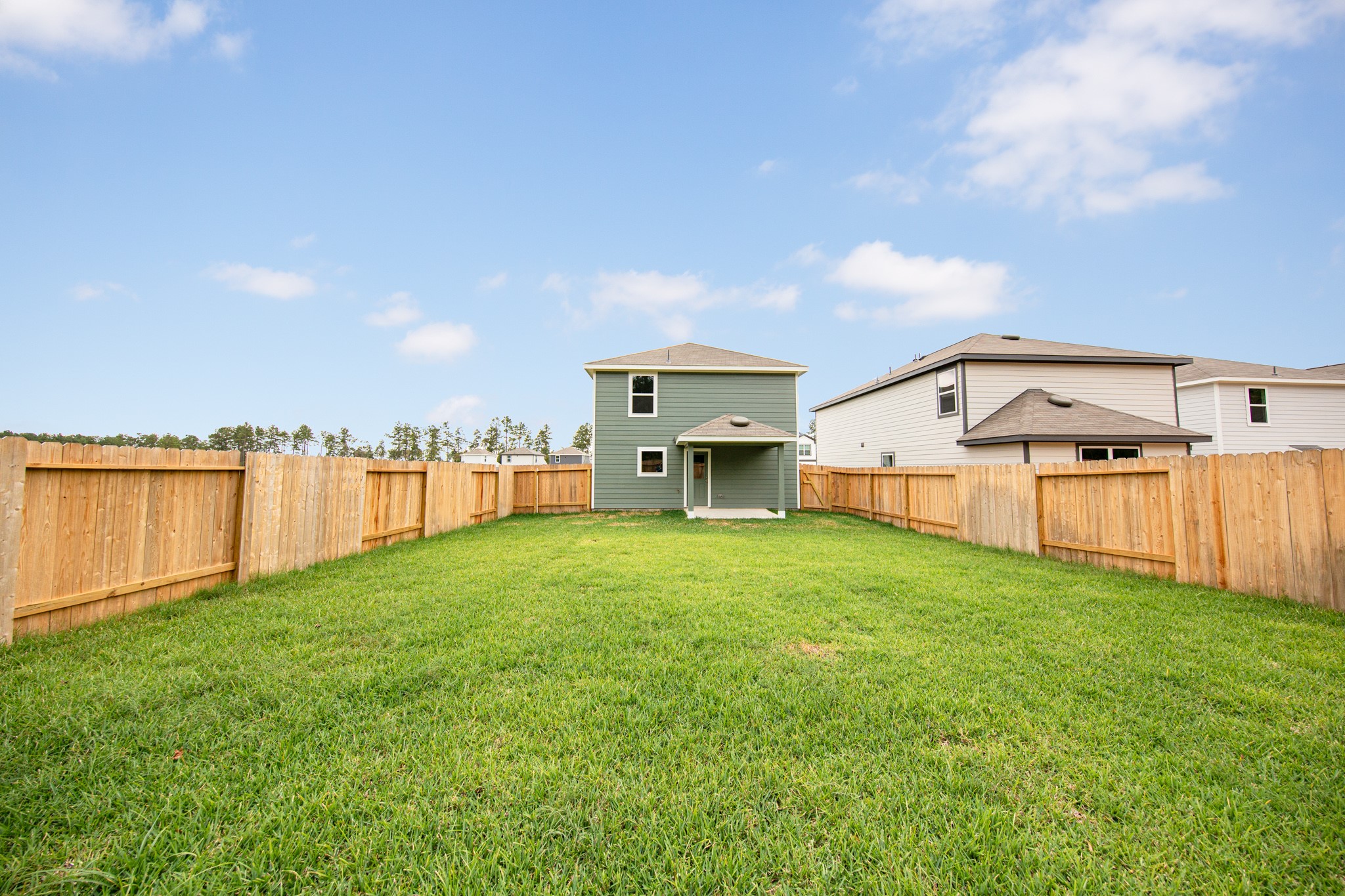 22759 American Kestrel Court Splendora, TX 77372 - Photo 14 of 23 a view of a big house with a big yard and large trees