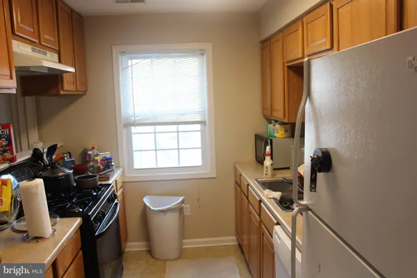 a kitchen with a sink stove and refrigerator