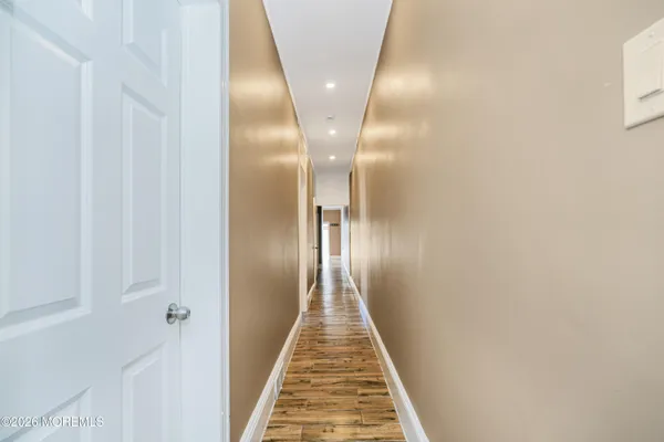 a view of a hallway with wooden floor