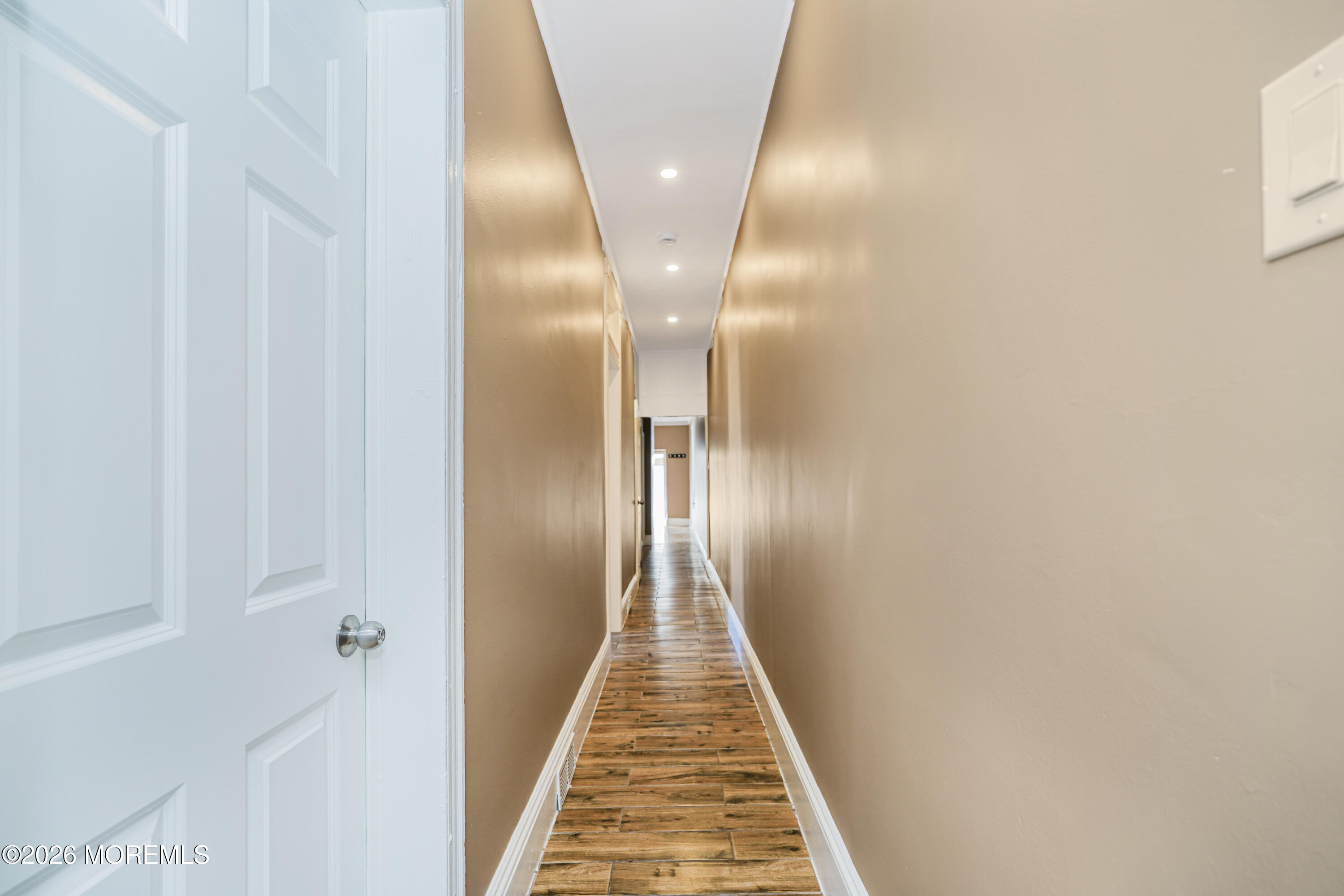 Undisclosed Address Matawan, NJ 07747 - Photo 12 of 18 a view of a hallway with wooden floor