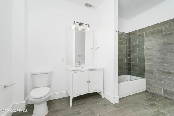 a bathroom with a toilet a sink and shower