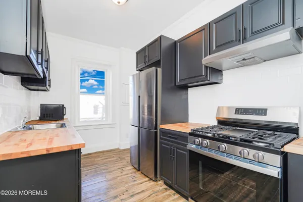 a kitchen with stainless steel appliances a sink a stove and a refrigerator