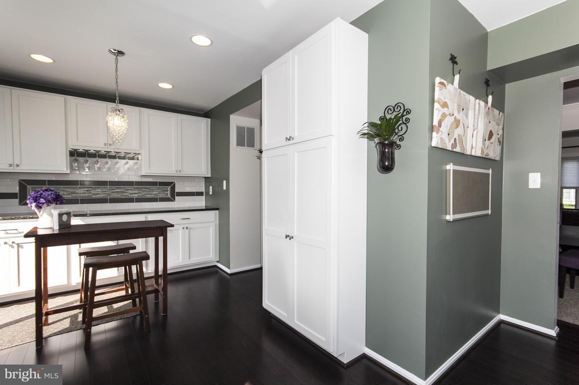 15 Robin Ridge Court Baltimore, MD 21234 - Photo 12 of 30 a kitchen with kitchen island white cabinets and stainless steel appliances
