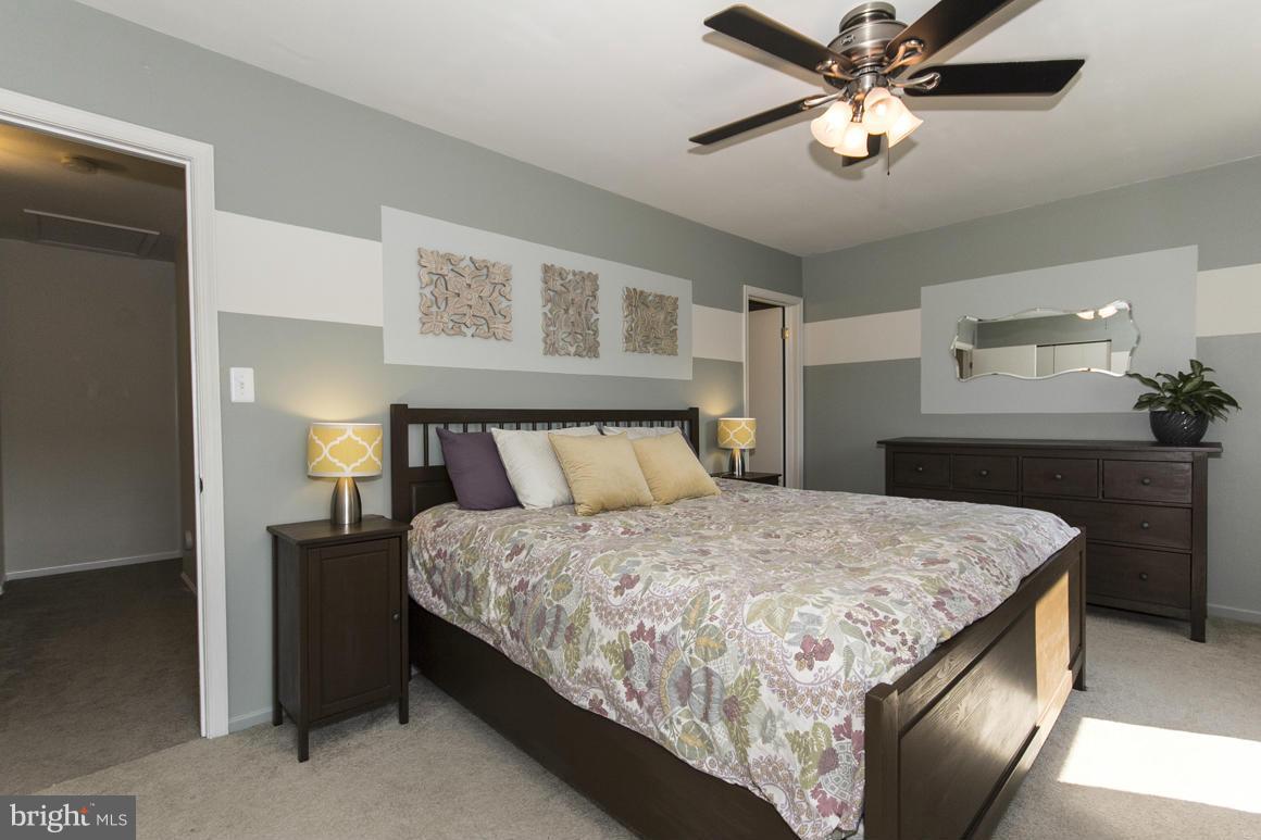 15 Robin Ridge Court Baltimore, MD 21234 - Photo 17 of 30 a bedroom with a bed and a chandelier
