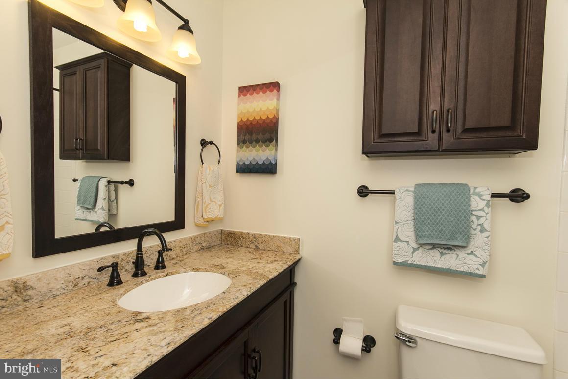 15 Robin Ridge Court Baltimore, MD 21234 - Photo 22 of 30 a bathroom with a granite countertop sink and a mirror
