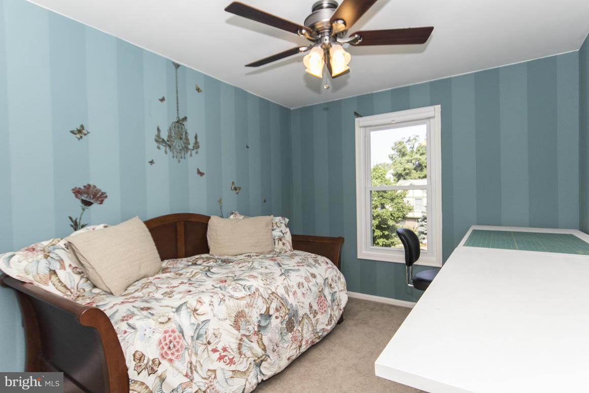 15 Robin Ridge Court Baltimore, MD 21234 - Photo 23 of 30 a bedroom with a large bed and a chandelier
