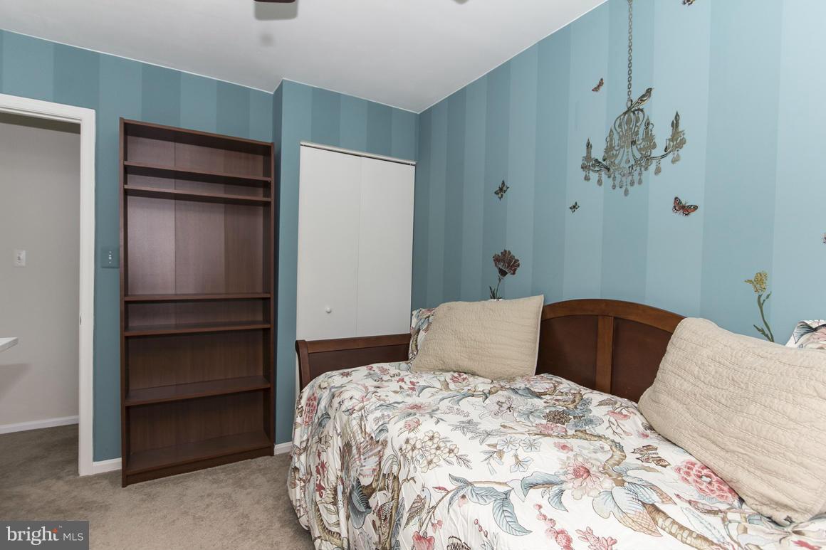 15 Robin Ridge Court Baltimore, MD 21234 - Photo 24 of 30 a bedroom with a bed and a wall painting
