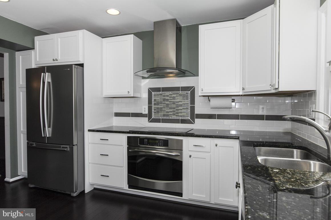 15 Robin Ridge Court Baltimore, MD 21234 - Photo 7 of 30 a kitchen with stainless steel appliances granite countertop a refrigerator stove and sink