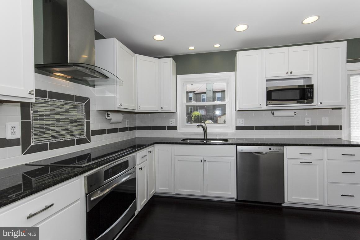 15 Robin Ridge Court Baltimore, MD 21234 - Photo 9 of 30 a kitchen with stainless steel appliances granite countertop a sink and stove top oven