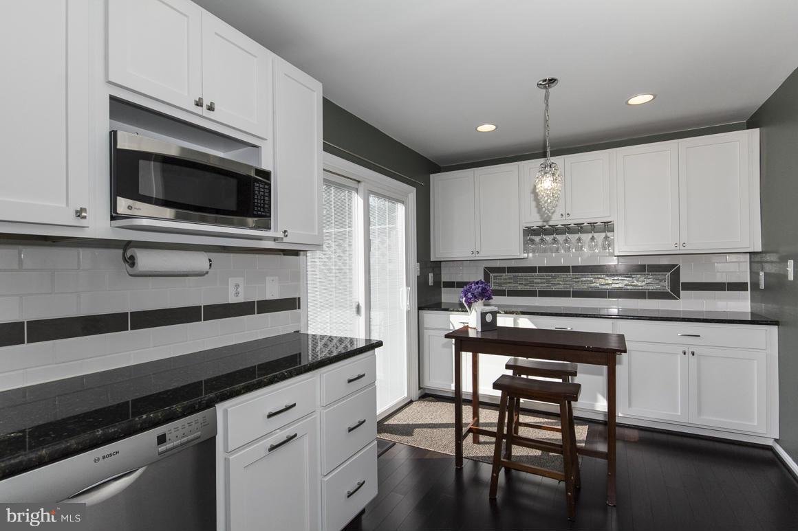 15 Robin Ridge Court Baltimore, MD 21234 - Photo 10 of 30 a kitchen with granite countertop white cabinets and appliances