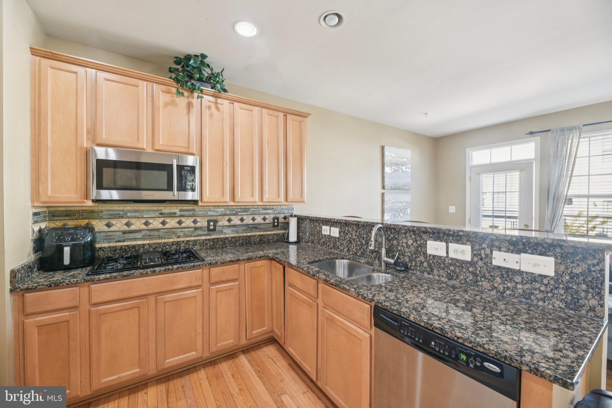 4334 Talmadge Circle Suitland, MD 20746 - Photo 13 of 29 a kitchen with granite countertop a sink a counter top space cabinets and stainless steel appliances