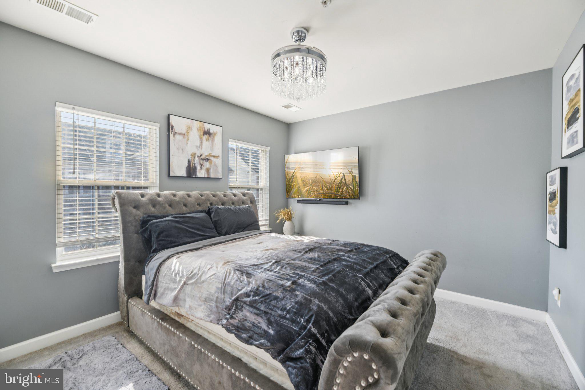 4334 Talmadge Circle Suitland, MD 20746 - Photo 18 of 29 a bedroom with a bed and a chandelier