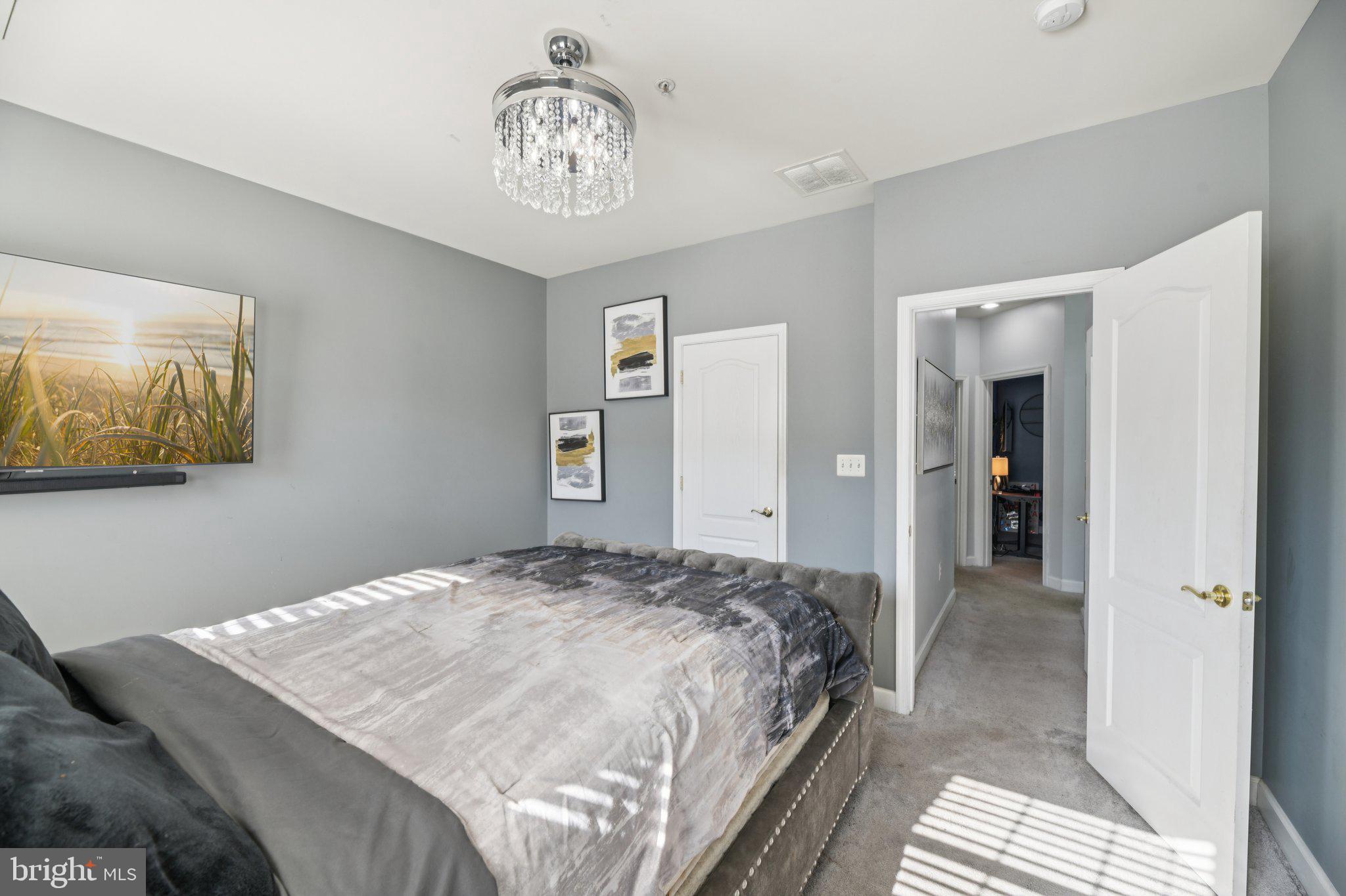 4334 Talmadge Circle Suitland, MD 20746 - Photo 19 of 29 a bedroom with a bed and a chandelier