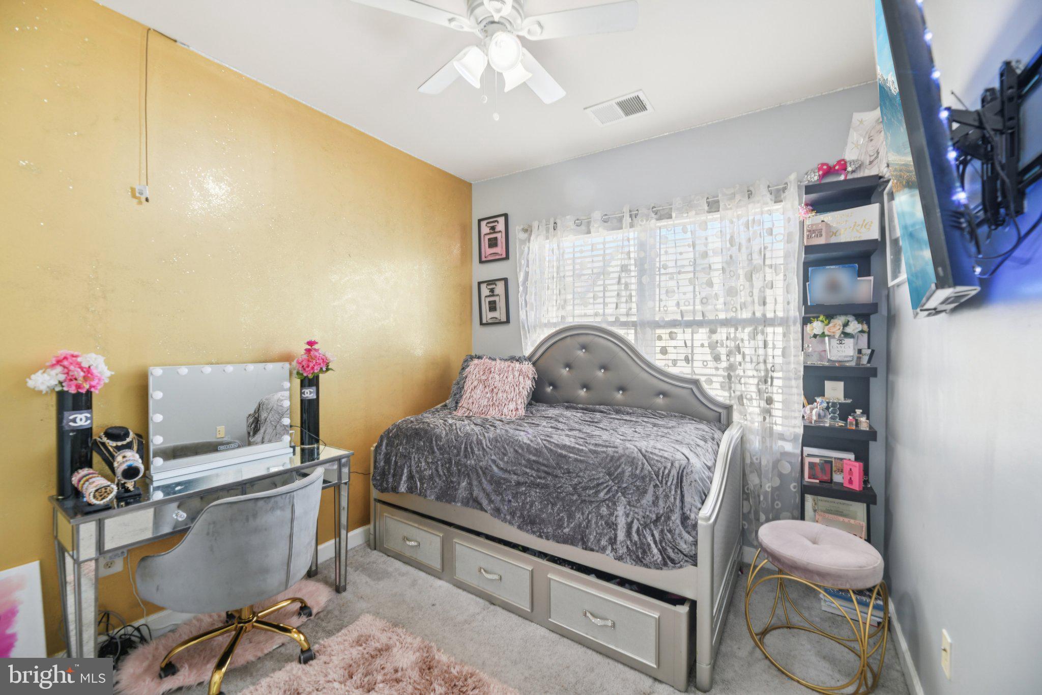 4334 Talmadge Circle Suitland, MD 20746 - Photo 23 of 29 a bedroom with a bed and a chandelier