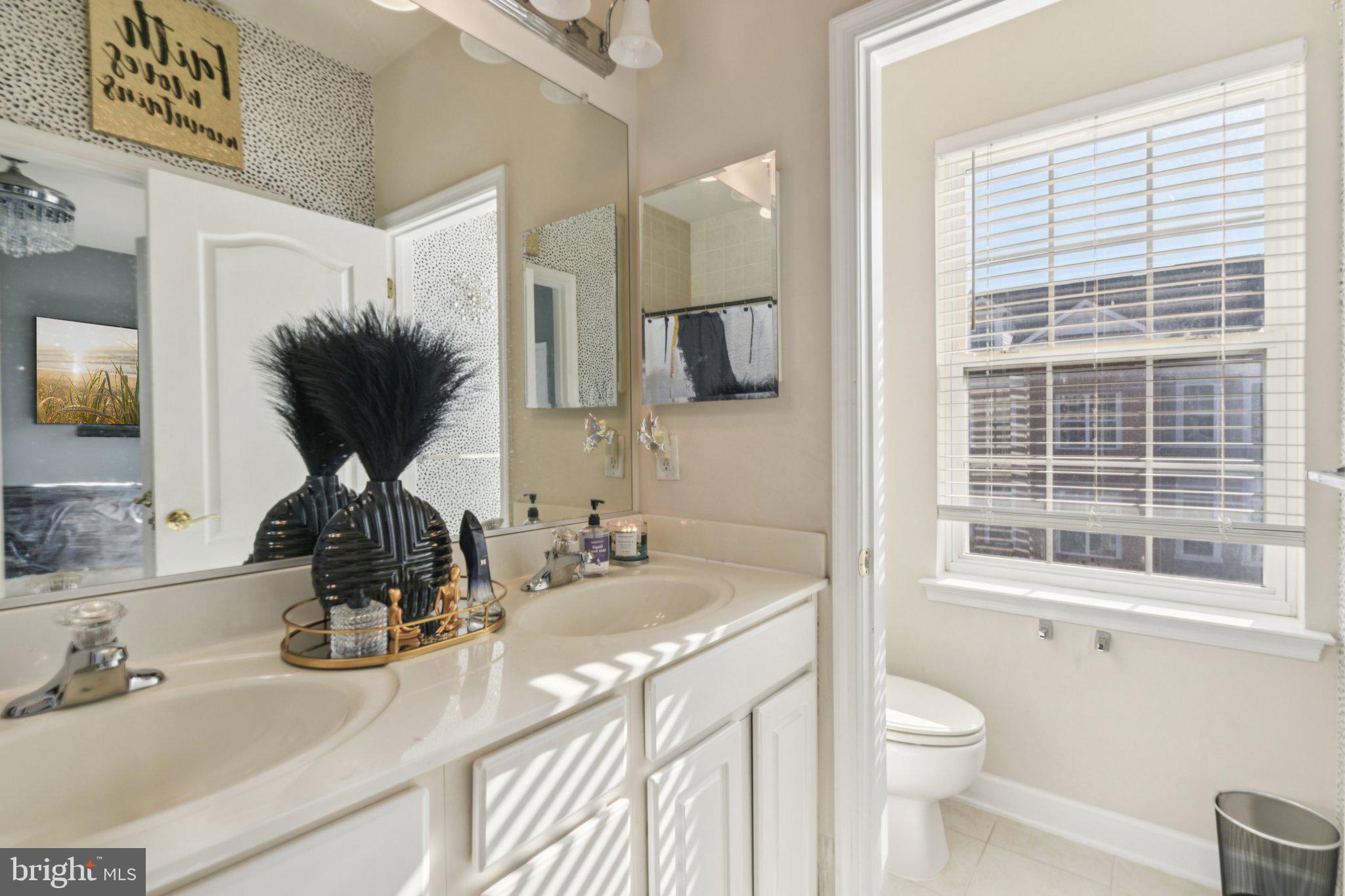 4334 Talmadge Circle Suitland, MD 20746 - Photo 26 of 29 a bathroom with a sink toilet and mirror
