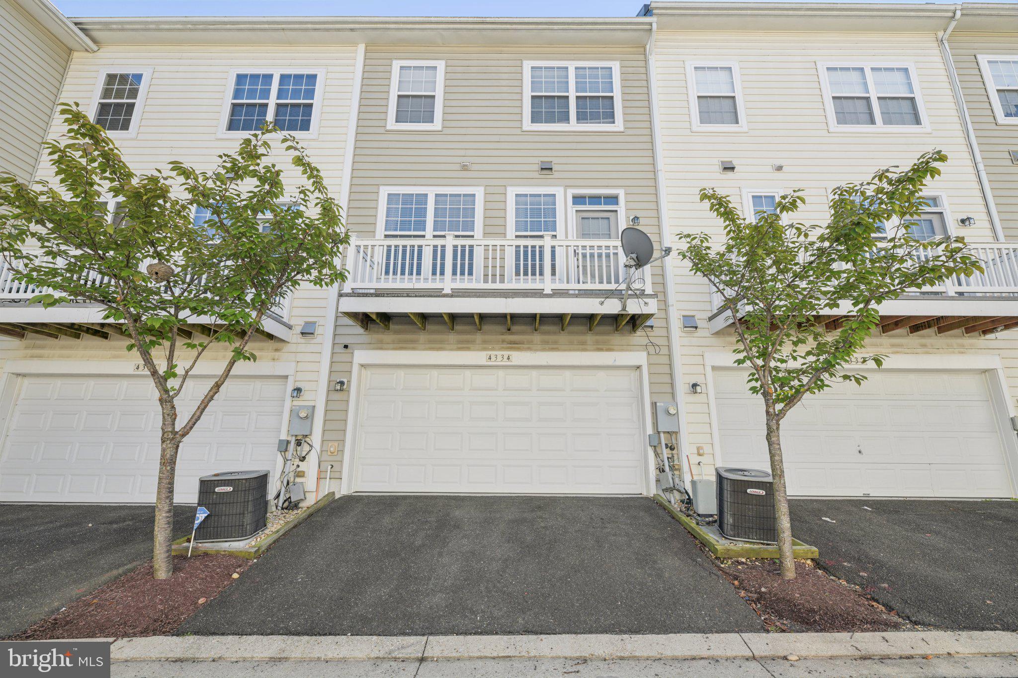 4334 Talmadge Circle Suitland, MD 20746 - Photo 28 of 29 a front view of a house with a yard and garage