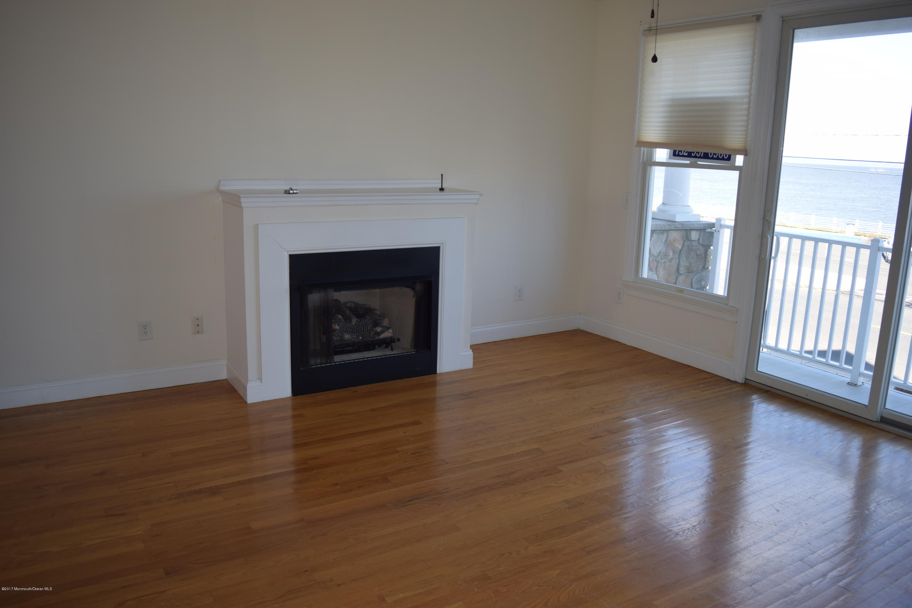 612 Front Street, Unit 7 Union Beach, NJ 07735 - Photo 5 of 15 wooden floor fireplace and natural light in room