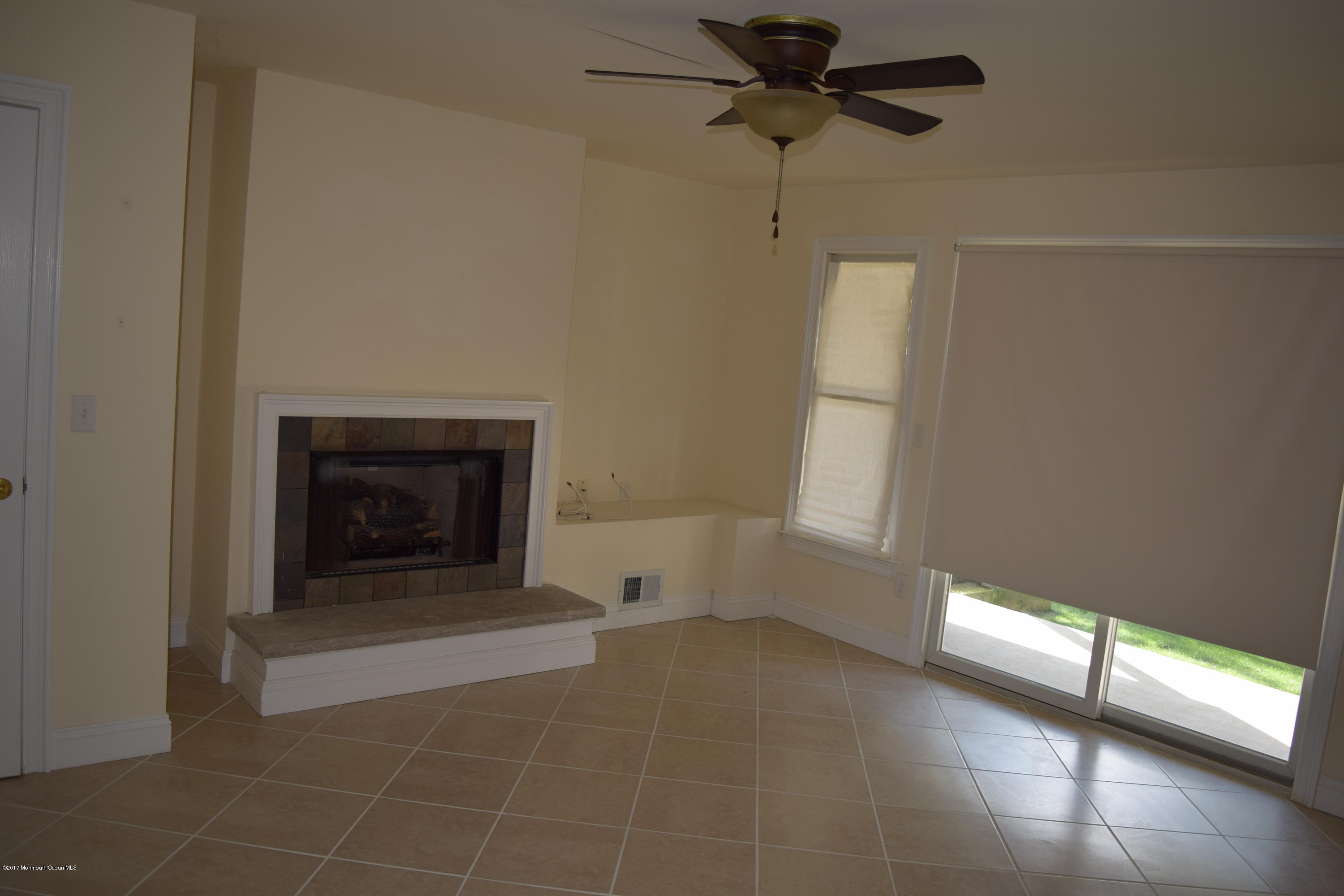 612 Front Street, Unit 7 Union Beach, NJ 07735 - Photo 10 of 15 a view of a livingroom with a fireplace and window
