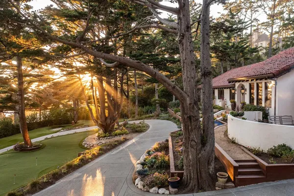 a view of a house with backyard sitting area and garden