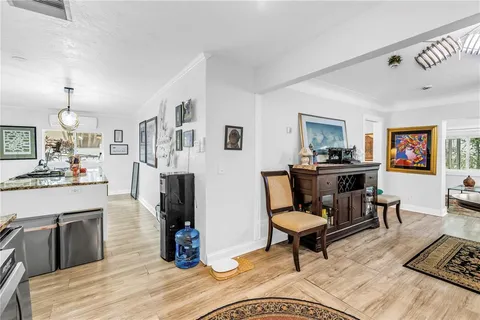 a kitchen with granite countertop a sink cabinets stainless steel appliances and a window