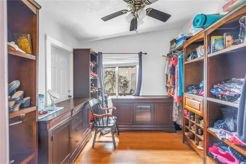a bedroom with a large bed and a chandelier fan