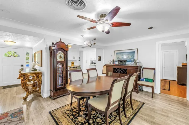 a living room with furniture a flat screen tv and a floor to ceiling window