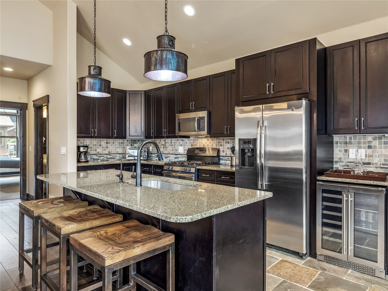 68 Independence Lane Keystone, CO 80435 - Photo 6 of 43 a kitchen with granite countertop a table chairs stainless steel appliances and cabinets