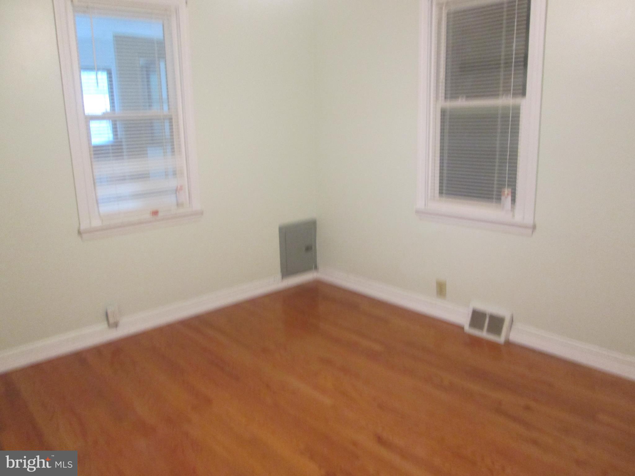 4511 Morgan Road Morningside, MD 20746 - Photo 3 of 16 a view of an empty room with wooden floor and a window