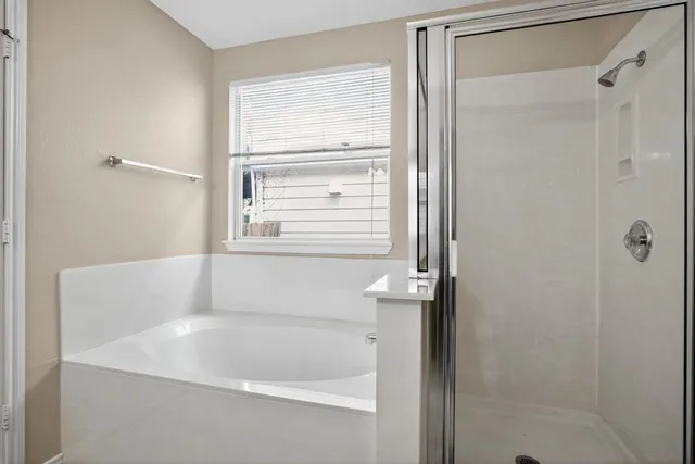 a white bath tub sitting next to a window