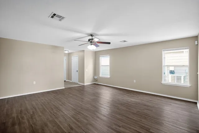 wooden floor in an empty room with a window