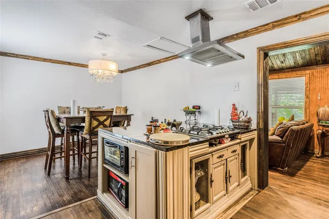 a kitchen that has a stove and a table