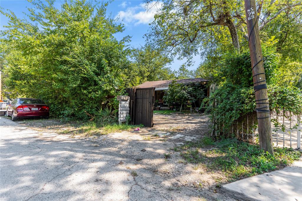 548 Elston Drive Dallas, TX 75232 - Photo 15 of 21 a view of a yard with car parked