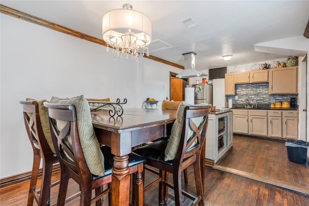 548 Elston Drive Dallas, TX 75232 - Photo 3 of 21 a view of a dining room with furniture and chandelier