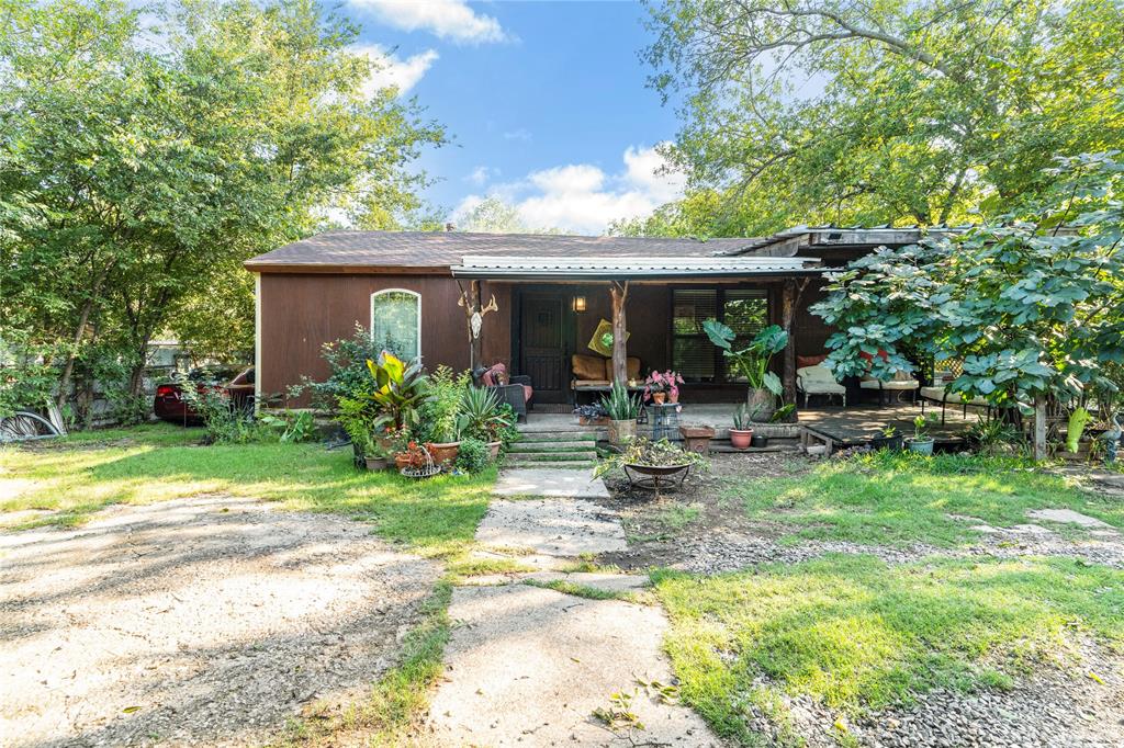 548 Elston Drive Dallas, TX 75232 - Photo 4 of 21 a view of a chair and table in backyard of the house