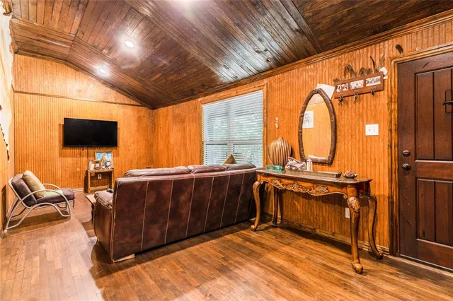 a view of a kitchen with furniture a flat screen tv and floor to ceiling window