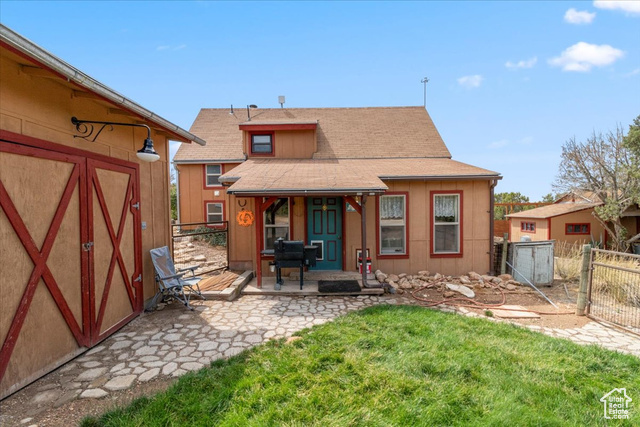11450 Pigeon Hollow Road Spring City, UT 84662 - Photo 19 of 47 Rear view of house with a patio, a shingled roof, a gate, and a storage unit