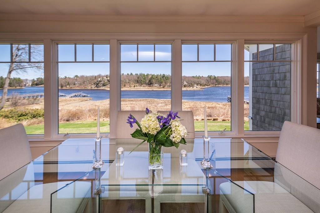 33 Stanton Road Cohasset, MA 02025 - Photo 16 of 40 a dining room with furniture and large windows