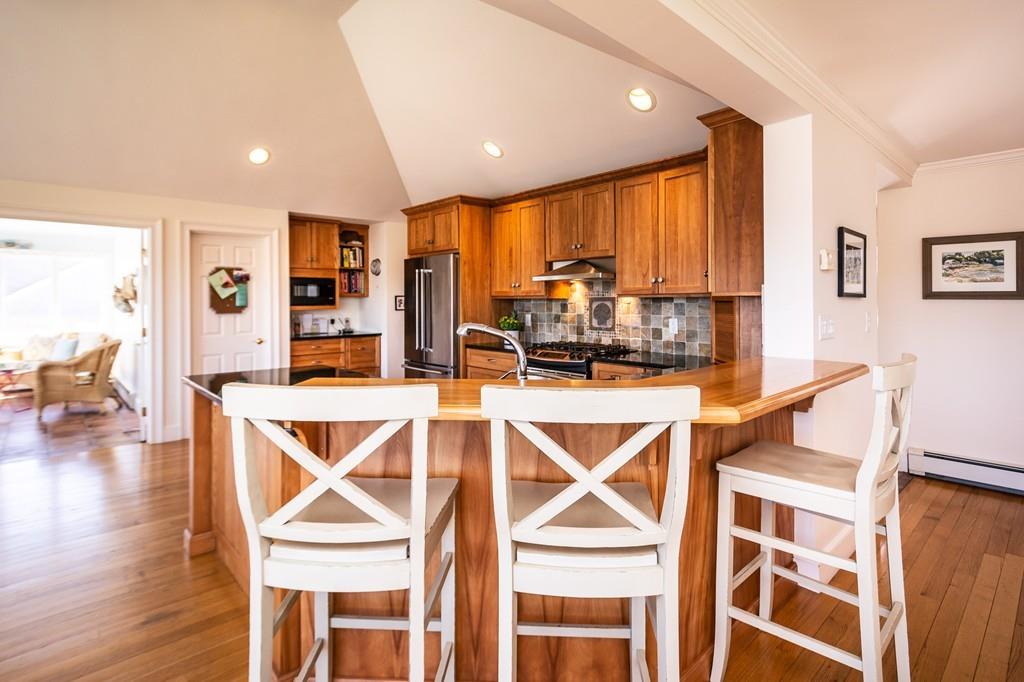 33 Stanton Road Cohasset, MA 02025 - Photo 22 of 40 a dining room with stainless steel appliances a dining table chairs and couches
