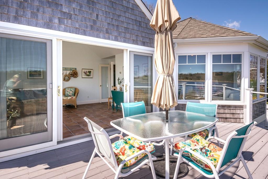 33 Stanton Road Cohasset, MA 02025 - Photo 25 of 40 a table and chairs in front of a house