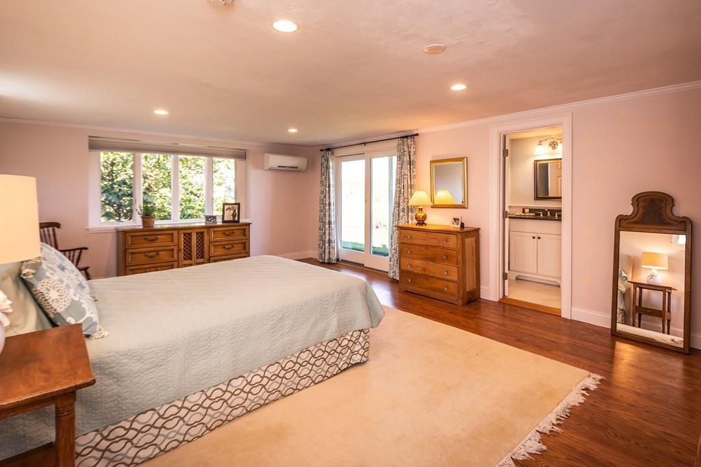 33 Stanton Road Cohasset, MA 02025 - Photo 32 of 40 a spacious bedroom with a bed and wooden floor