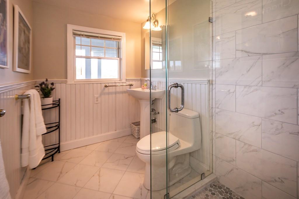 33 Stanton Road Cohasset, MA 02025 - Photo 36 of 40 a bathroom with a glass shower door and a sink