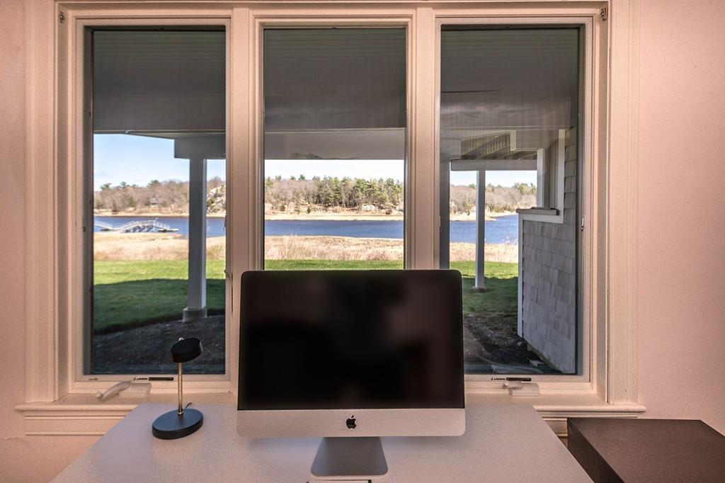 33 Stanton Road Cohasset, MA 02025 - Photo 38 of 40 a view of a floor to ceiling window and backyard with garden