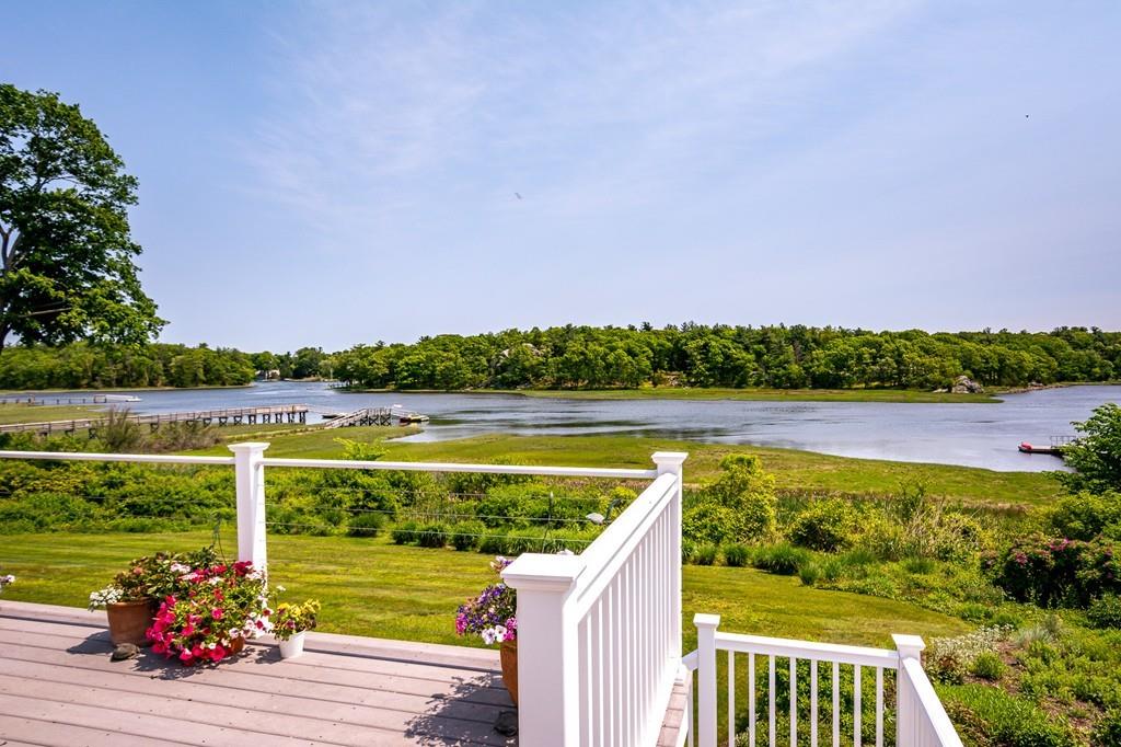 33 Stanton Road Cohasset, MA 02025 - Photo 6 of 40 a view of a lake with a garden