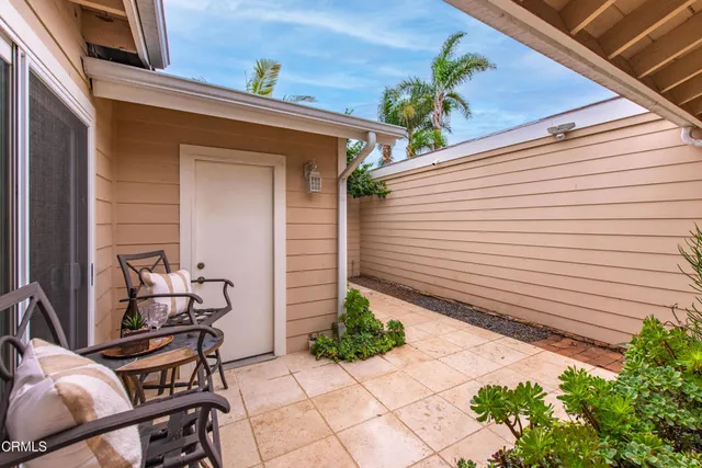 a view of a chairs and table in the back of the house