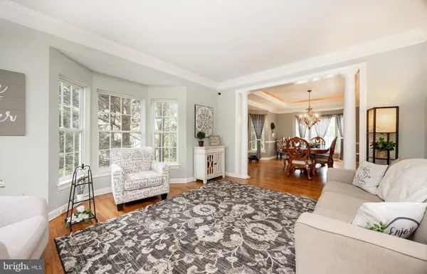 a view of a dining room with furniture large windows and wooden floor