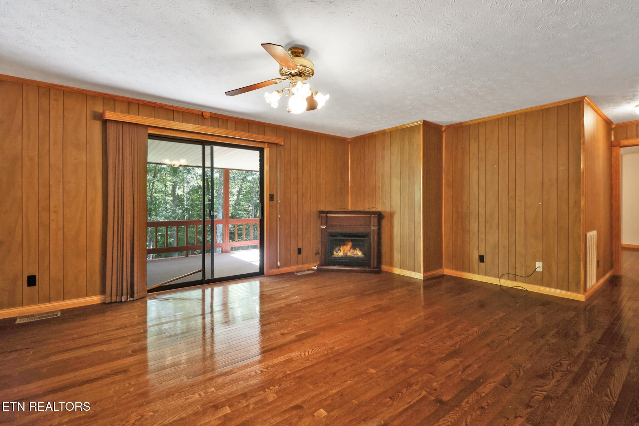 1190 Sand Cut Road Oneida, TN 37841 - Photo 14 of 41 a view of an empty room with a window and wooden floor