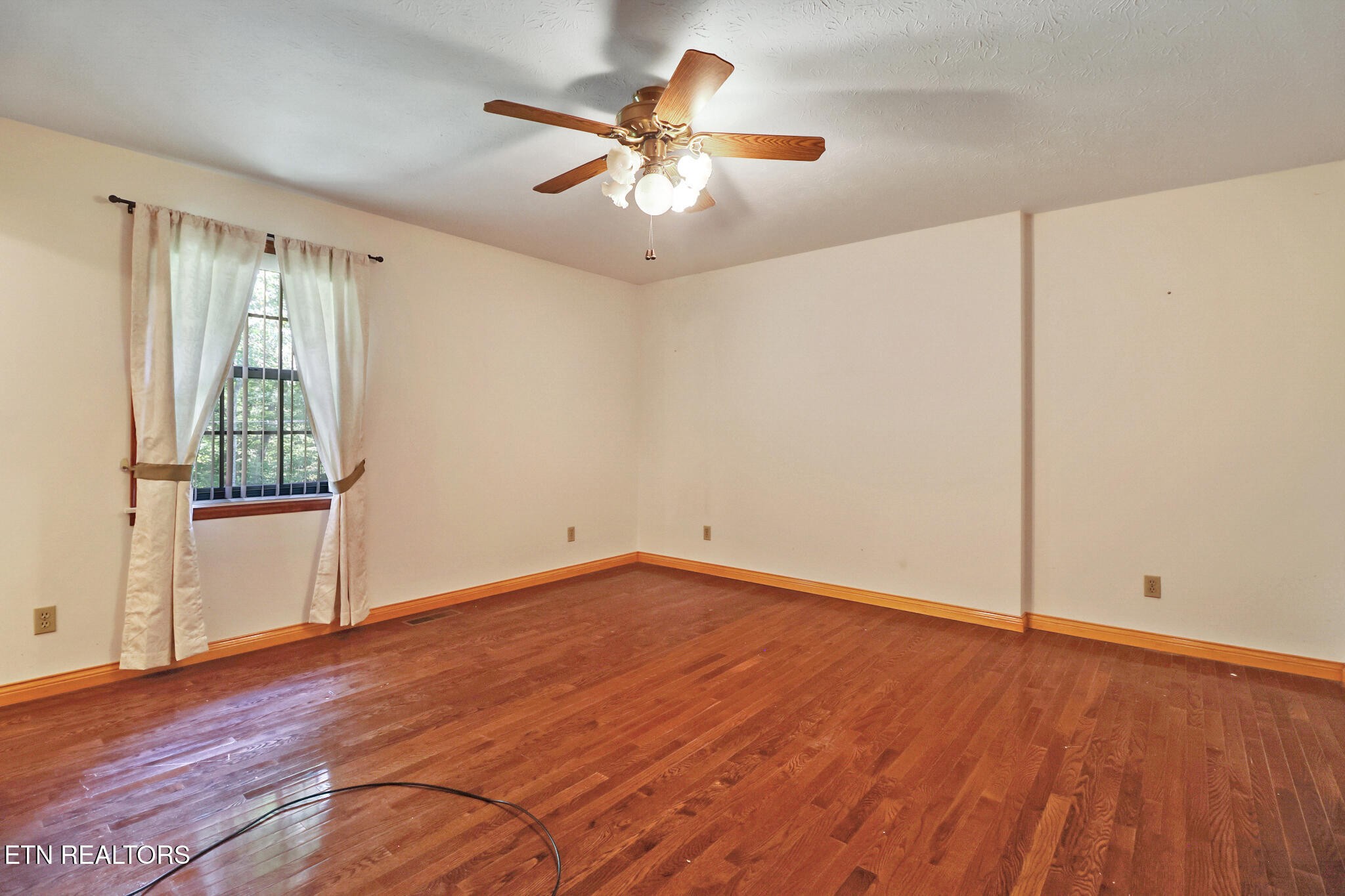 1190 Sand Cut Road Oneida, TN 37841 - Photo 20 of 41 wooden floor in an empty room with a window