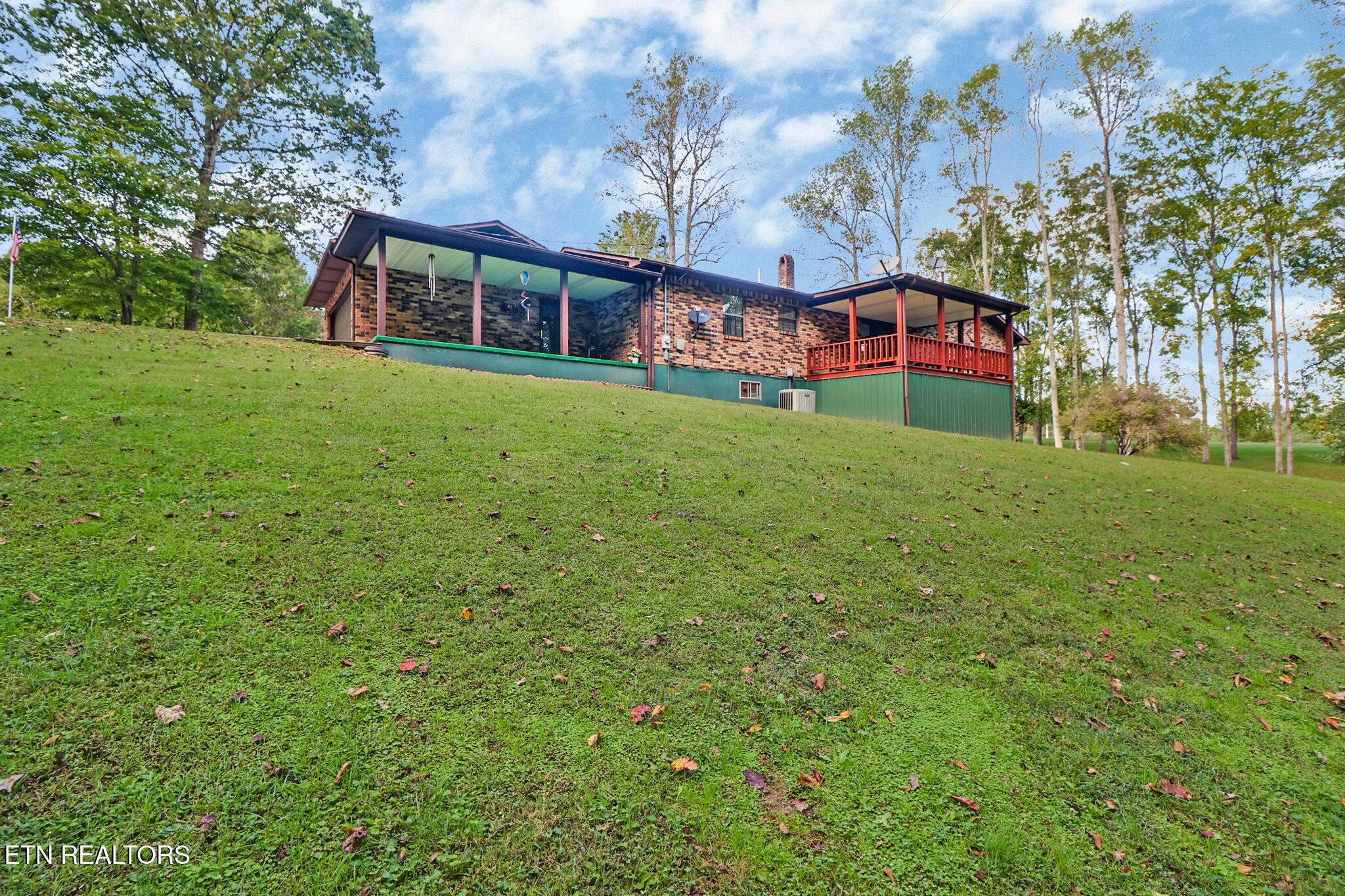 1190 Sand Cut Road Oneida, TN 37841 - Photo 39 of 41 a view of a house with a big yard and large trees