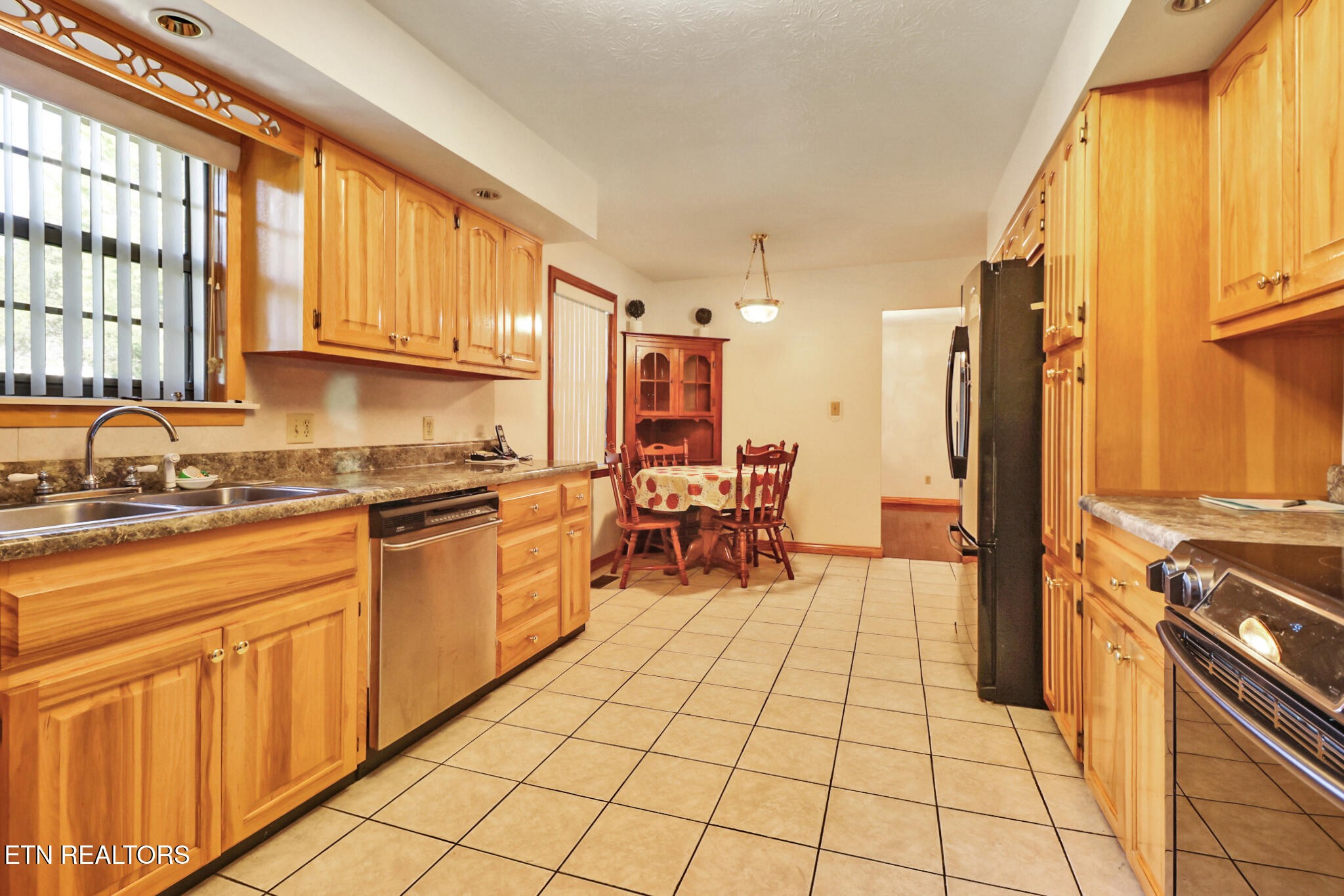 1190 Sand Cut Road Oneida, TN 37841 - Photo 4 of 41 a kitchen with stainless steel appliances granite countertop a stove a sink and a microwave