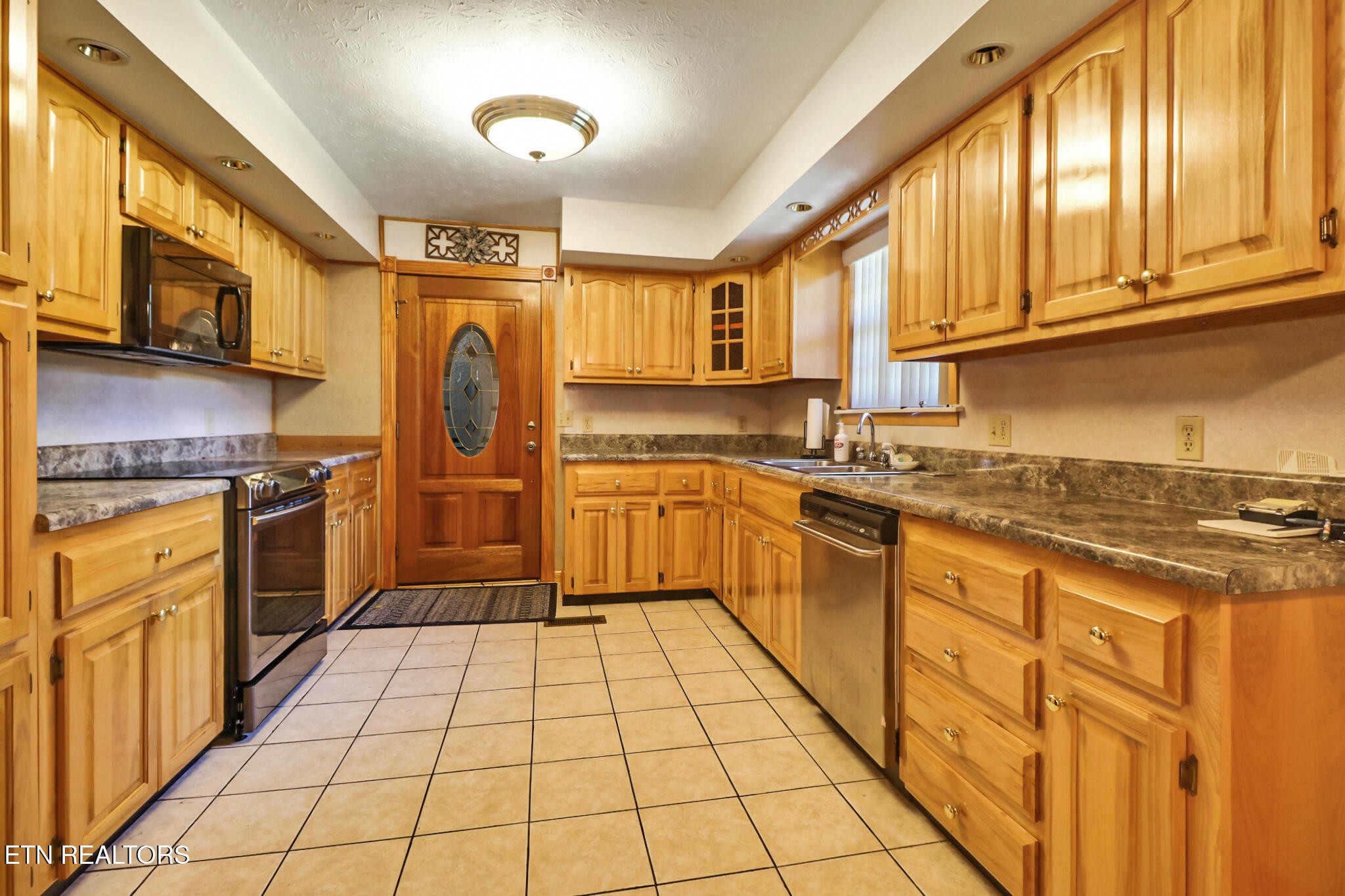 1190 Sand Cut Road Oneida, TN 37841 - Photo 5 of 41 a kitchen with stainless steel appliances granite countertop a stove top oven a sink dishwasher and cabinets with wooden floor